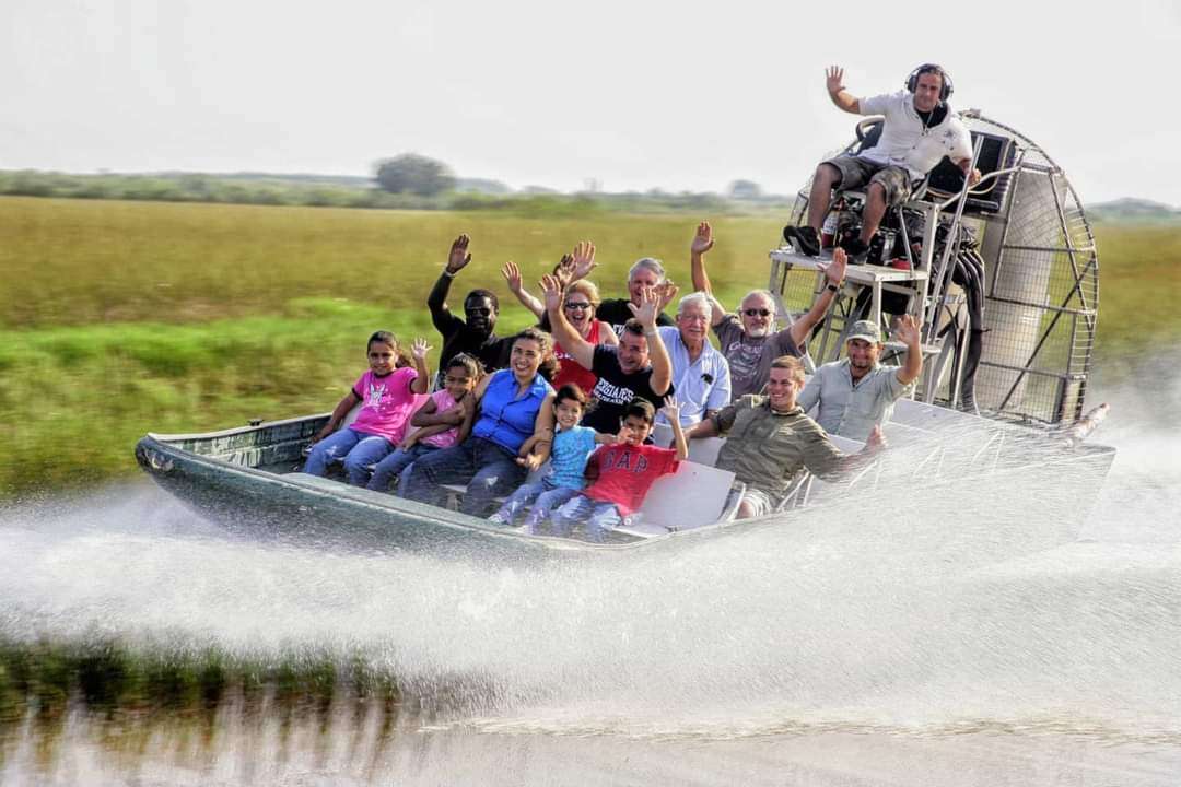 Visitors taking an airboat tour through Everglades sawgrass