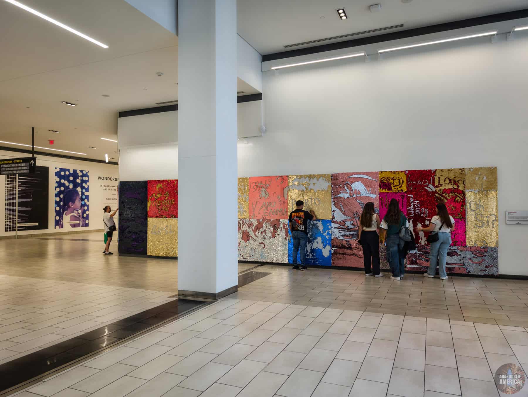 A new feature at modern malls: the fuzzy wall you can write on with your fingers
