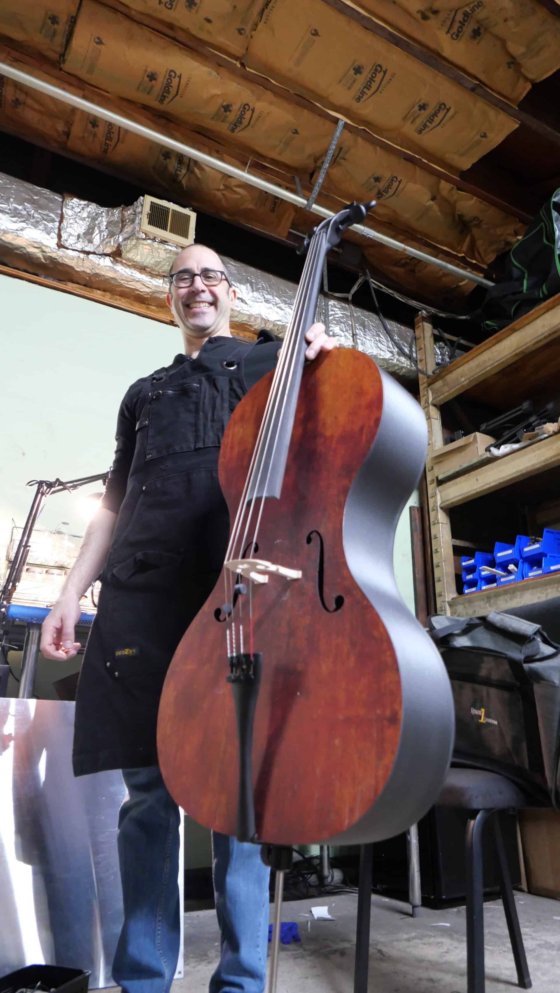 That's Alfred displaying a carbon fiber cello front, made to appear like antique wood!