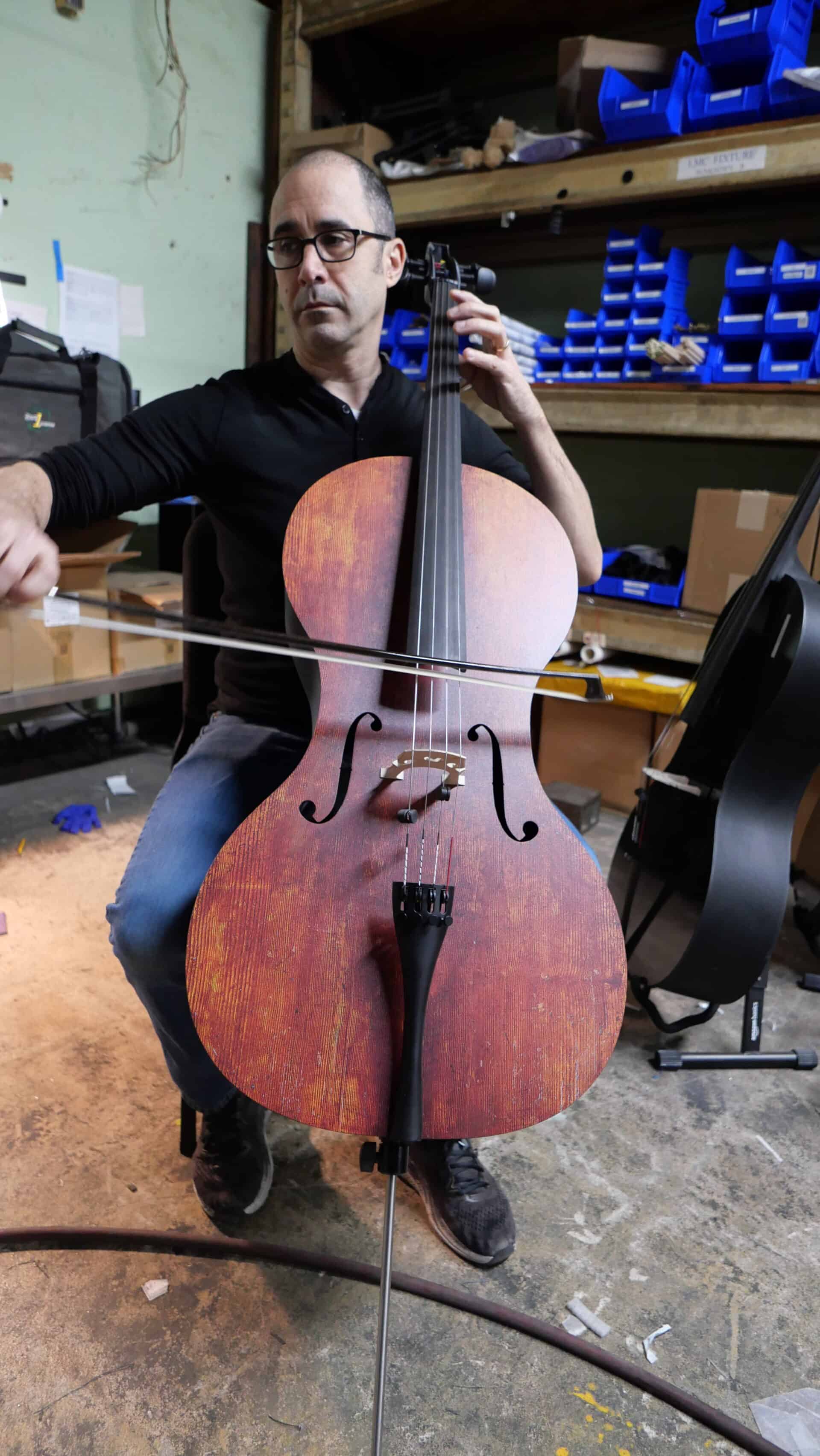 Alfred testing the cello that was made for Shark Tank investor, Laurie Greiner